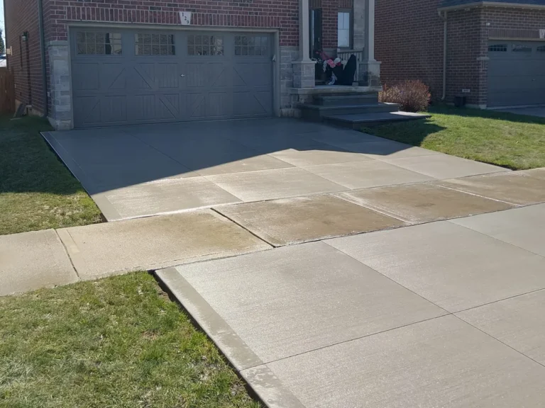 New concrete driveway with two-tone finish at a brick home in Hamilton & Niagara Region