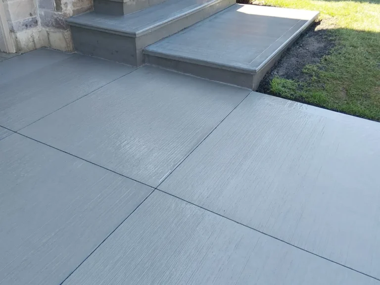 Concrete driveway and matching front steps installed by Custommade Concrete