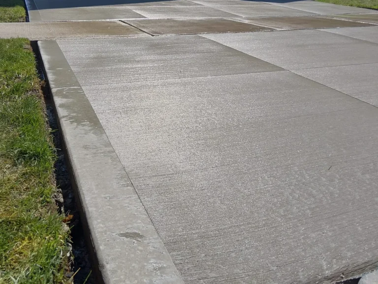 Close-up of a broom-finished concrete driveway surface