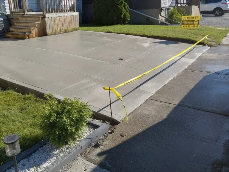 Concrete driveway installation in progress with safety tape