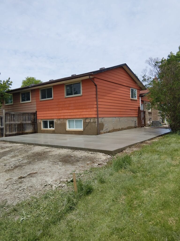 Concrete patios installation behind residential home